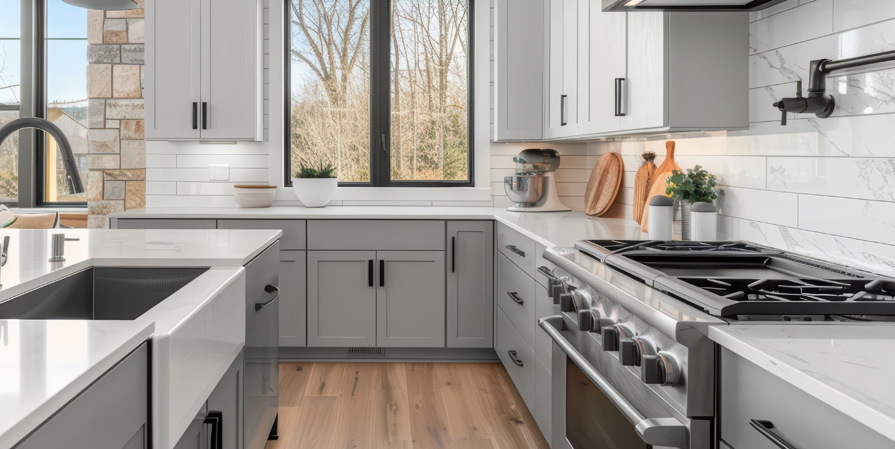 Grey shaker kitchen cabinetry with warm wood floors